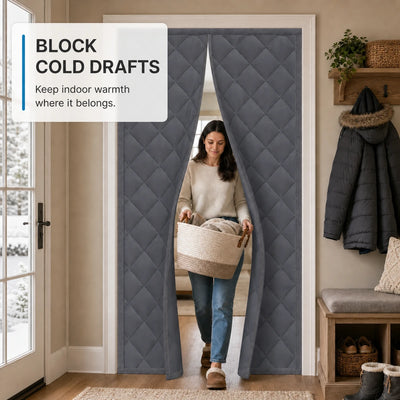Woman walking through gray insulated magnetic door curtain in a winter entryway